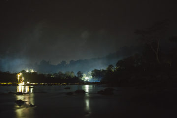 Night on the river with jungle behind